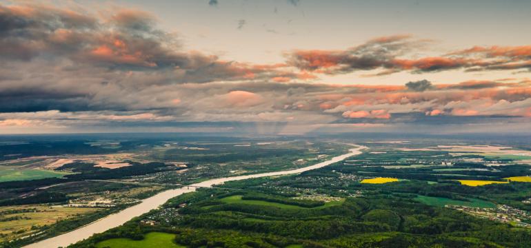 An image of the green countryside and sunset.