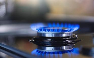 An image of a gas hob heating up a pan in a kitchen.