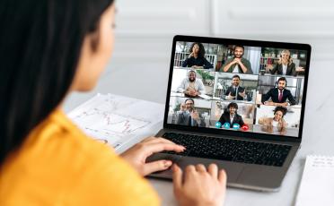 Image of a woman taking part in an online webinar