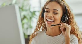 Image of a woman speaking on a headset to a customer.